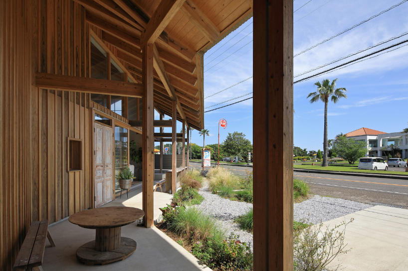 a forest of wooden pillars topped by a gently arched roof shape anandah café and residence - 5