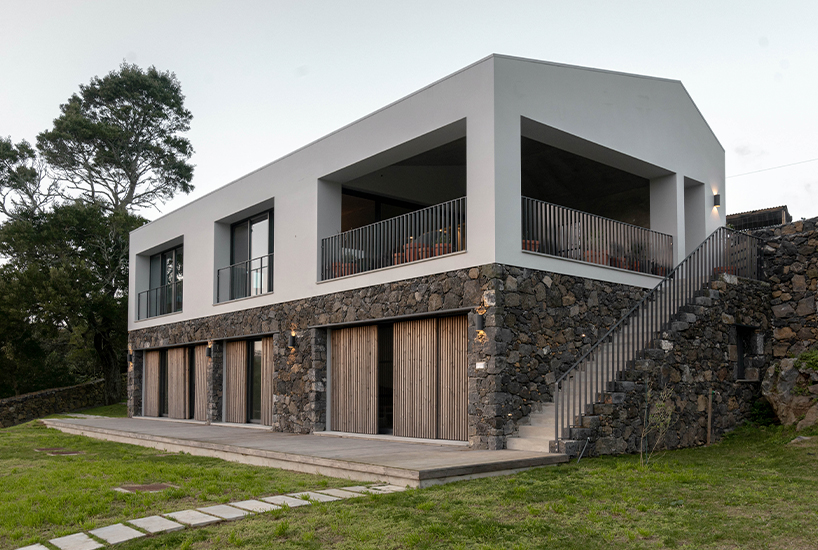 mezzo atelier completes concrete + local basalt stone dwelling in são miguel island