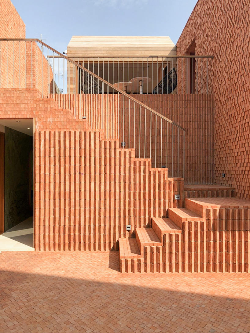 handmade bricks form the 'baan pomphet' restaurant and hotel in ayutthaya, thailand designboom