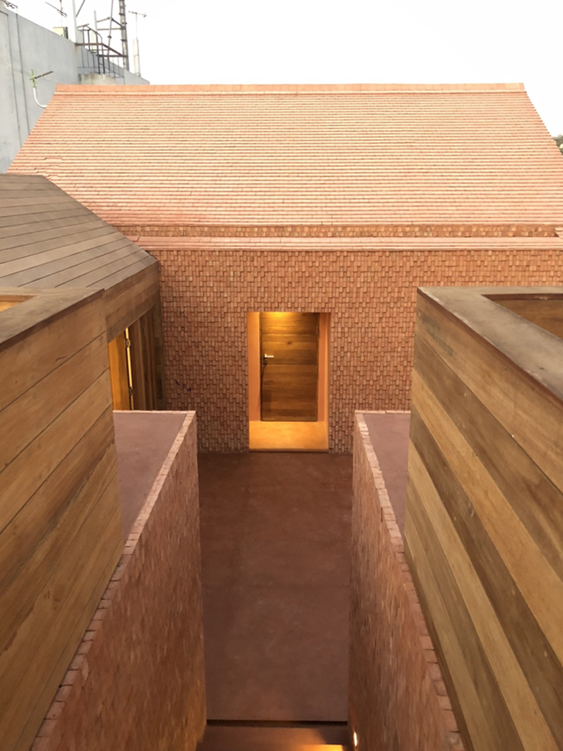 handmade bricks form the 'baan pomphet' restaurant and hotel in ayutthaya, thailand designboom