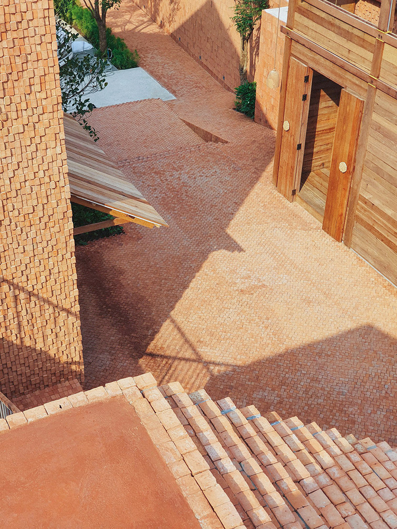 handmade bricks form the 'baan pomphet' restaurant and hotel in ayutthaya, thailand designboom
