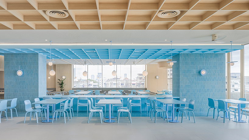 baby blue hues engulf onion's multipurpose school canteen in bangkok