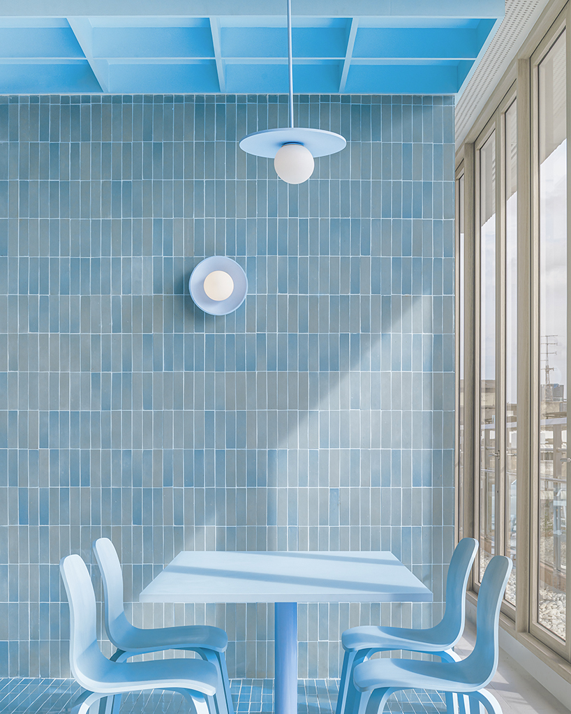 baby blue hues engulf onion's multipurpose school canteen in bangkok