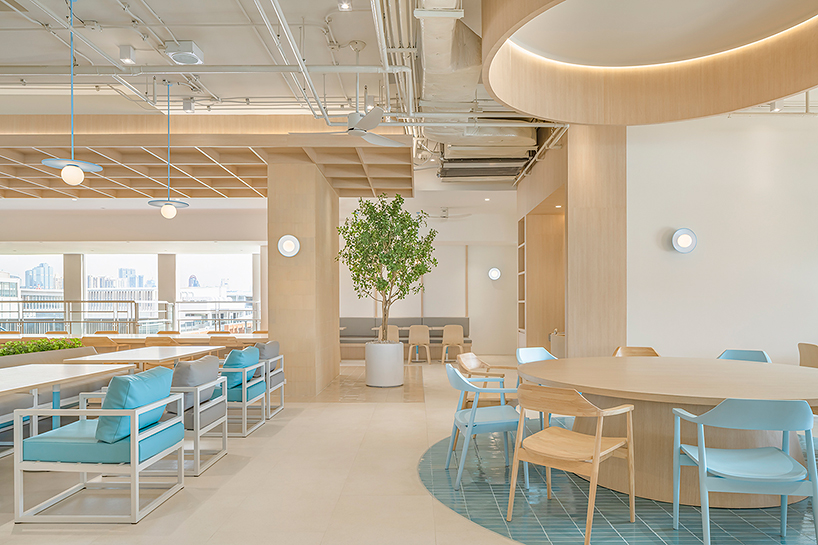 baby blue hues engulf onion's multipurpose school canteen in bangkok