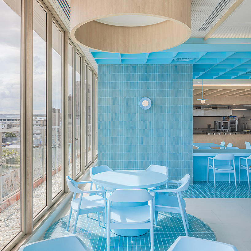 baby blue hues engulf onion's multipurpose school canteen in bangkok