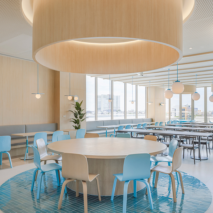 baby blue hues engulf onion's multipurpose school canteen in bangkok