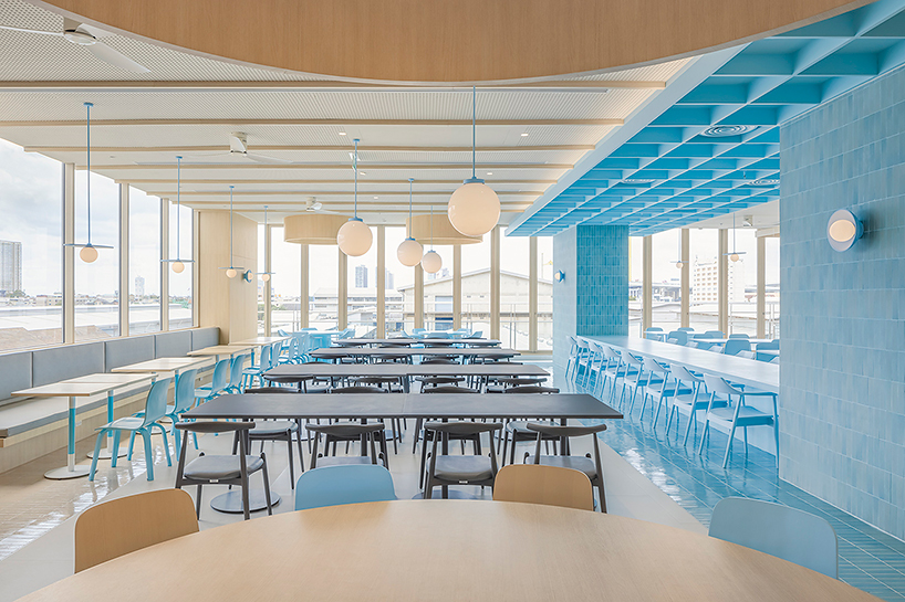 baby blue hues engulf onion's multipurpose school canteen in bangkok