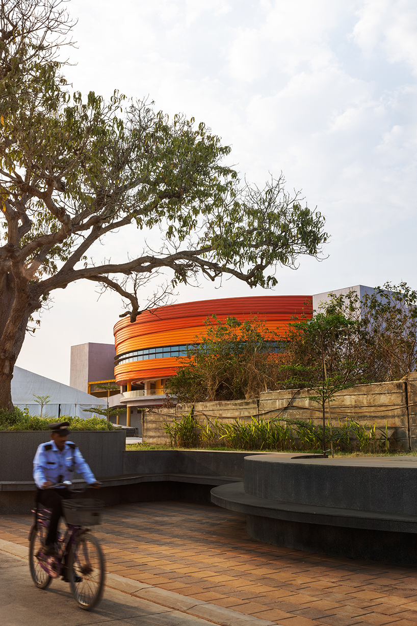 purple ink studio's winding ramps connect concentric plaza to auditorium at university campus in bangalore