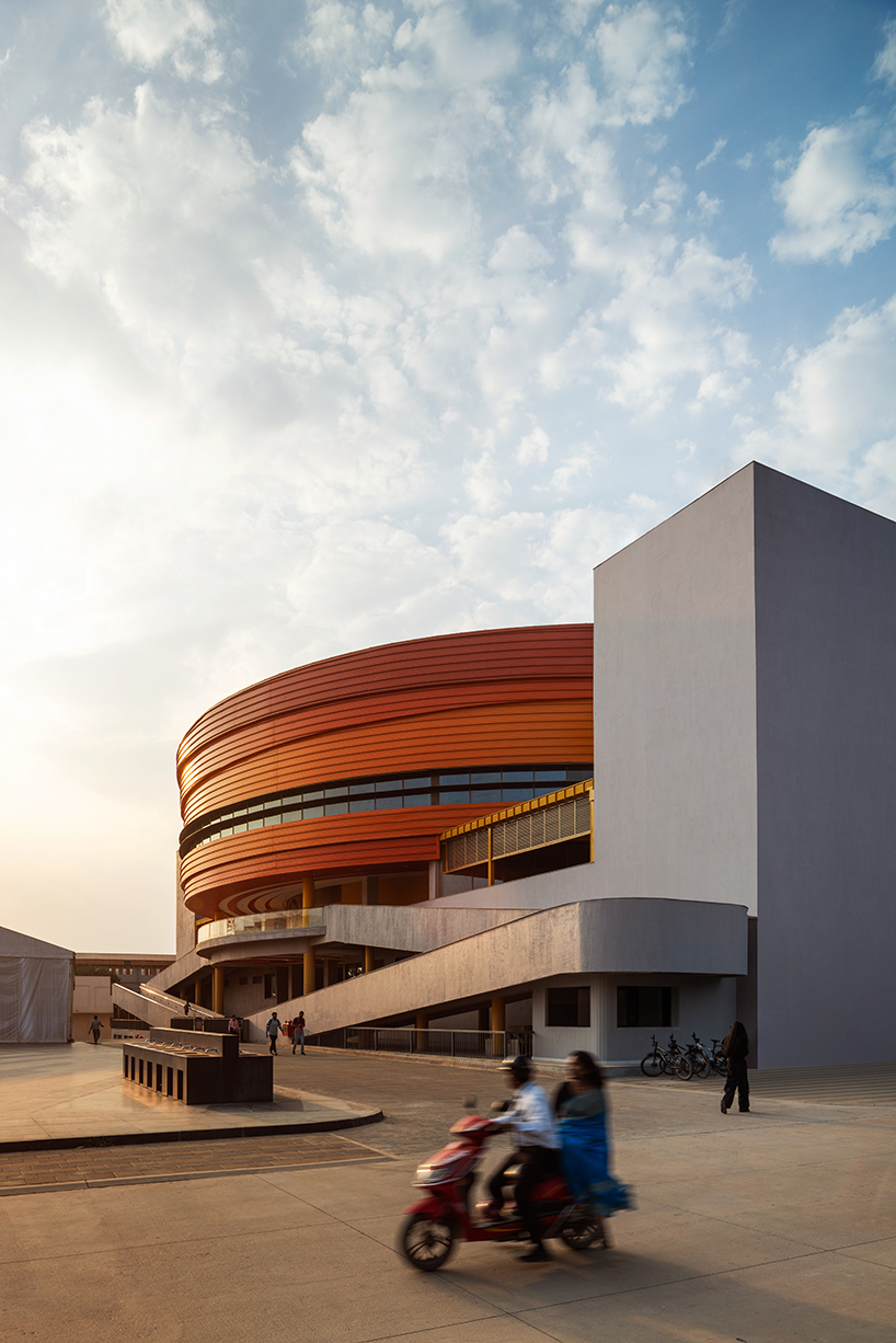 purple ink studio's winding ramps connect concentric plaza to auditorium at university campus in bangalore