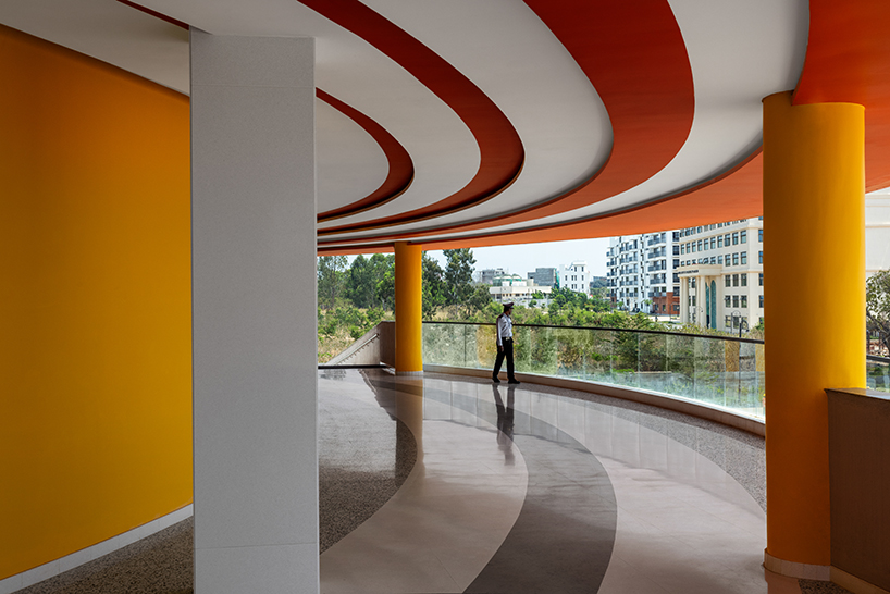 purple ink studio's winding ramps connect concentric plaza to auditorium at university campus in bangalore