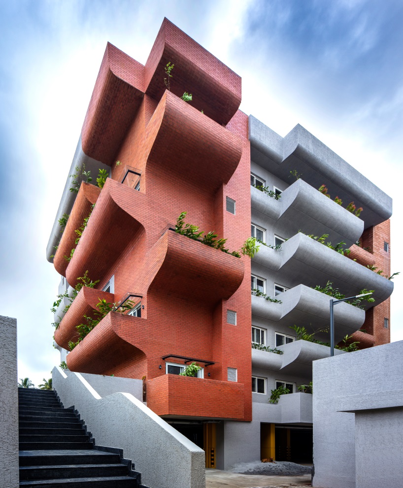 curving balconies double as environmental filters at purple ink studio's housing complex in bangalore