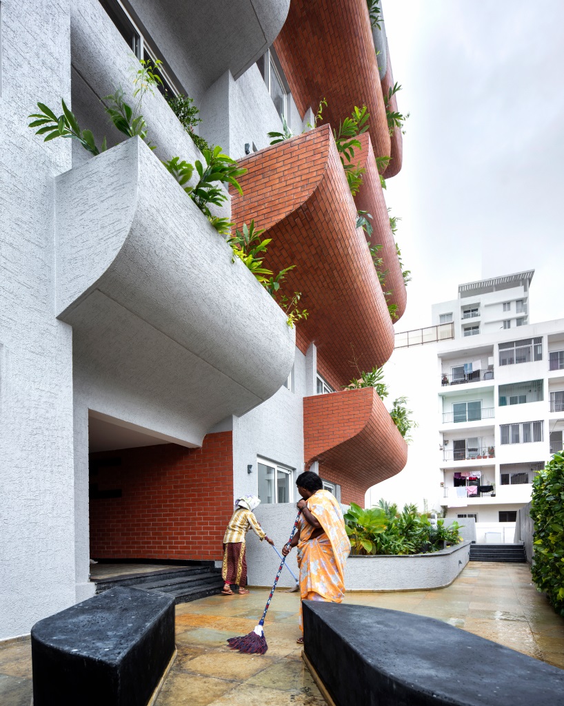 curving balconies double as environmental filters at purple ink studio's housing complex in bangalore