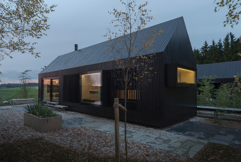 format elf nestles dark barn-shaped houses into bavarian ...
