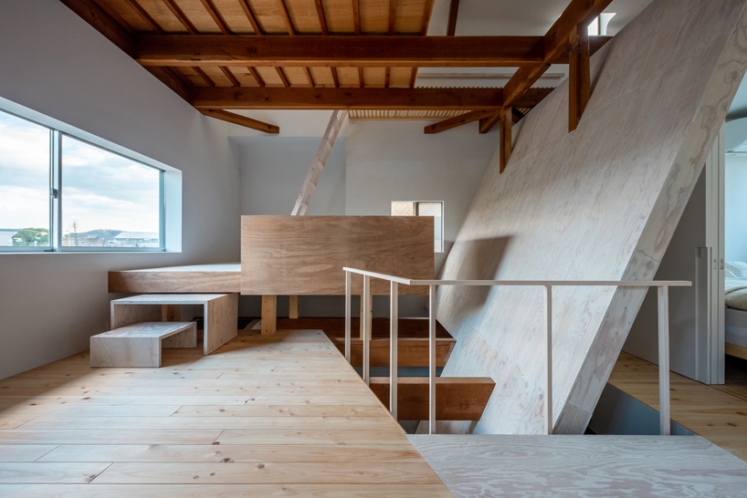 long diagonal wall carves up this renovated 40-year-old wooden house in japan