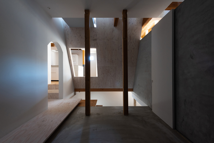 long diagonal wall carves up this renovated 40-year-old wooden house in japan