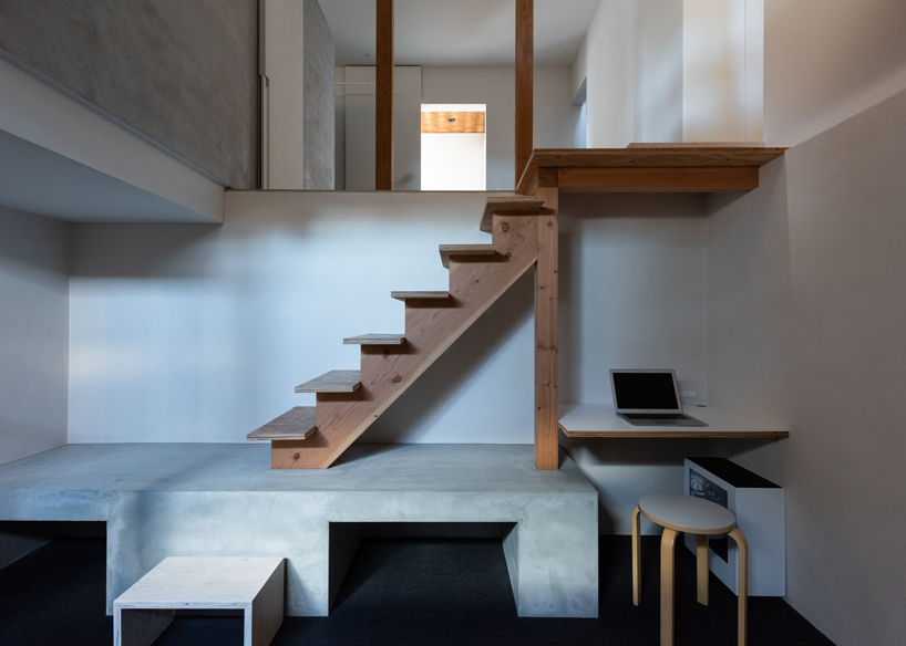 long diagonal wall carves up this renovated 40-year-old wooden house in japan