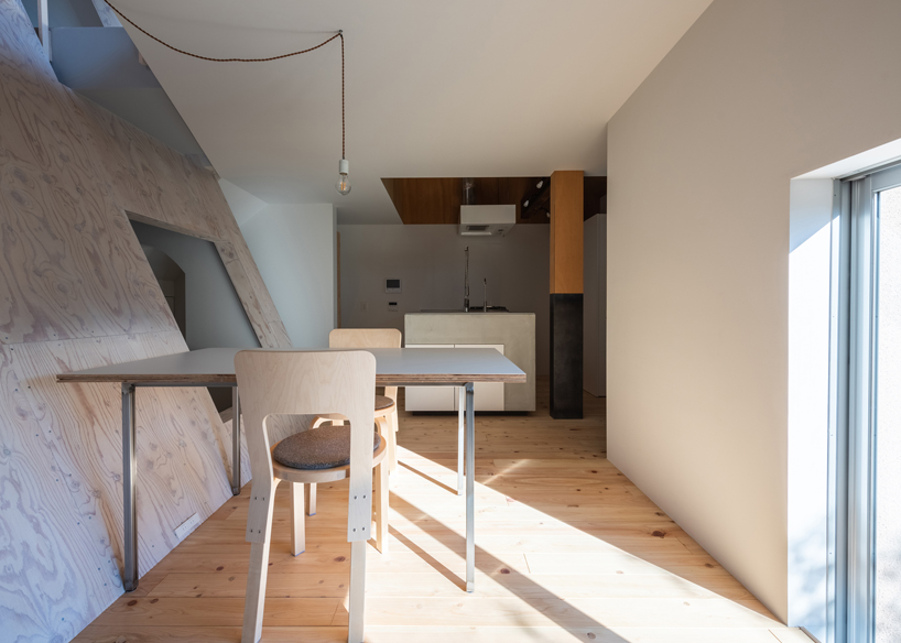 long diagonal wall carves up this renovated 40-year-old wooden house in japan