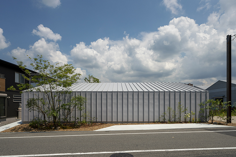 arbol design wraps a riverside house in metal cladding in osaka, japan designboom