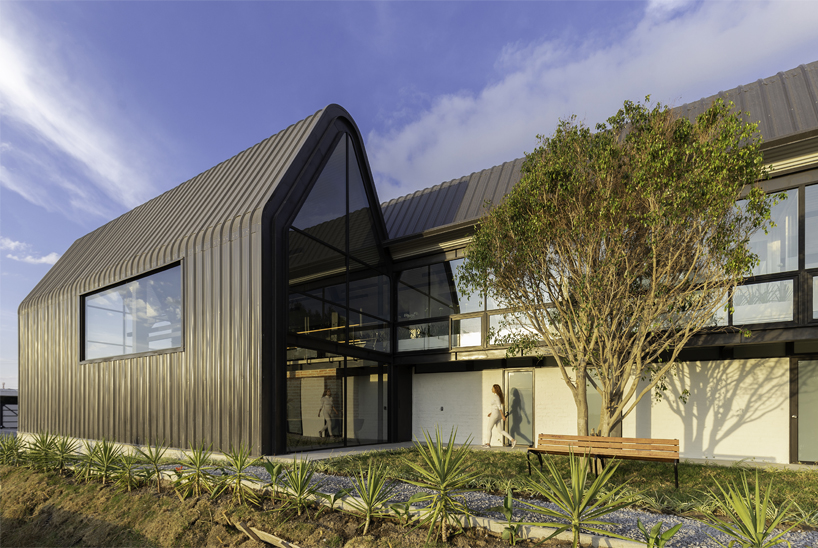 estudio felipe escudero designs a series of gable roofs clad in black aluminium