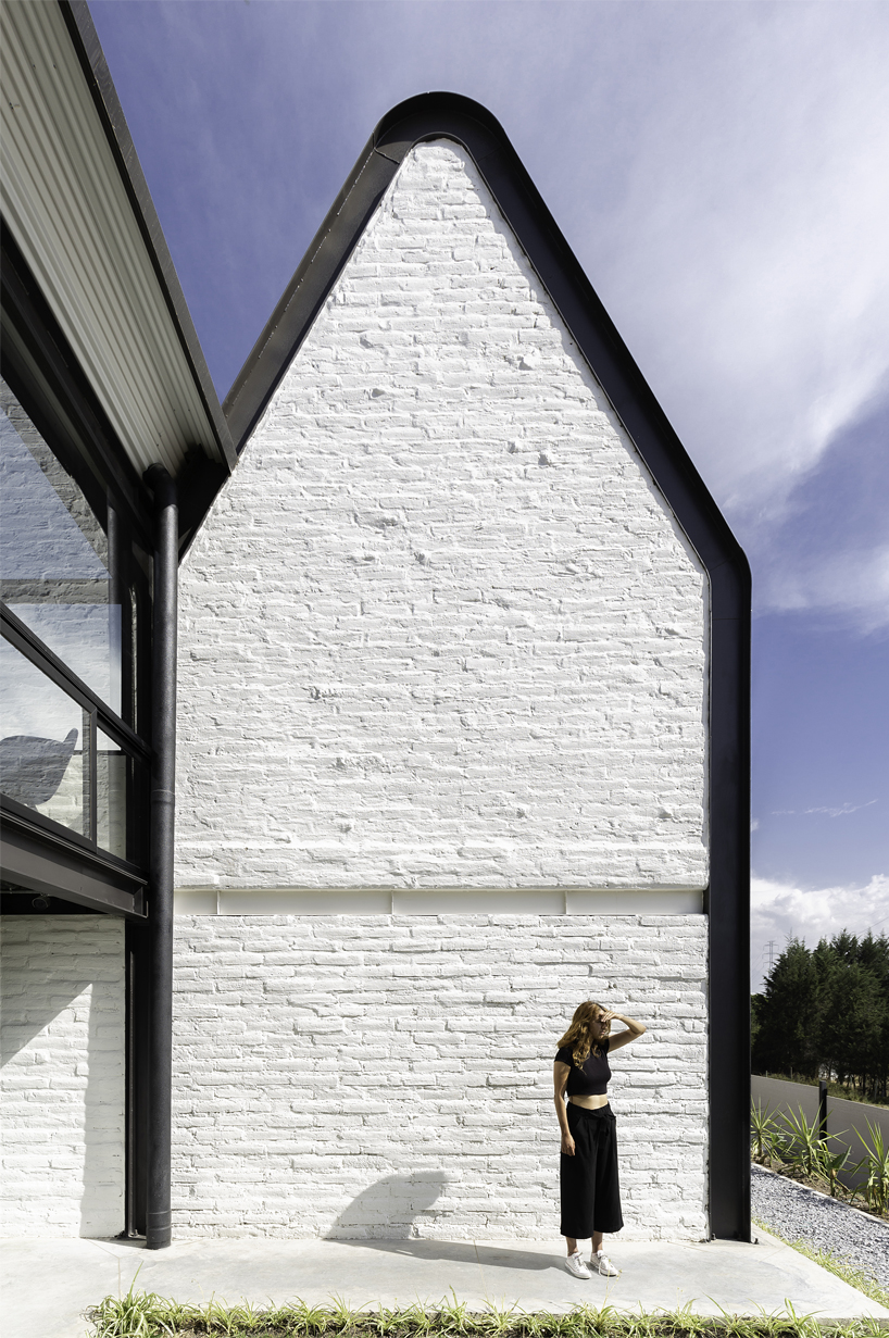 estudio felipe escudero designs a series of gable roofs clad in black aluminium