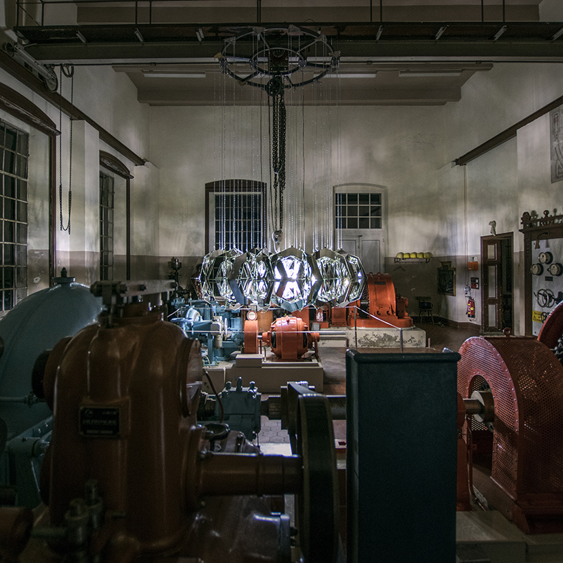 thomas medicus suspends turbine-shaped glass installation at hydropower plant in austria