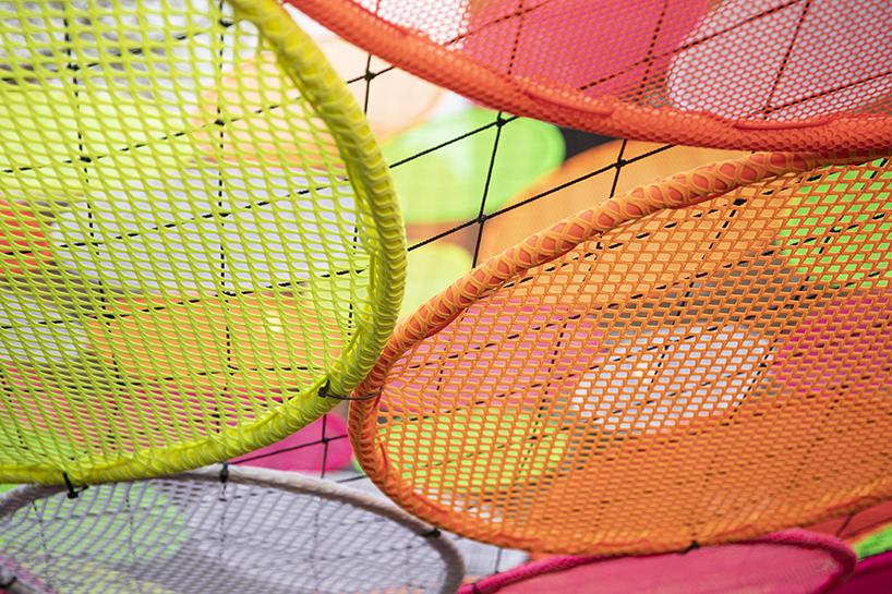 hou de sousa suspends the multi-colored 'atomic' installation in georgetown DC designboom