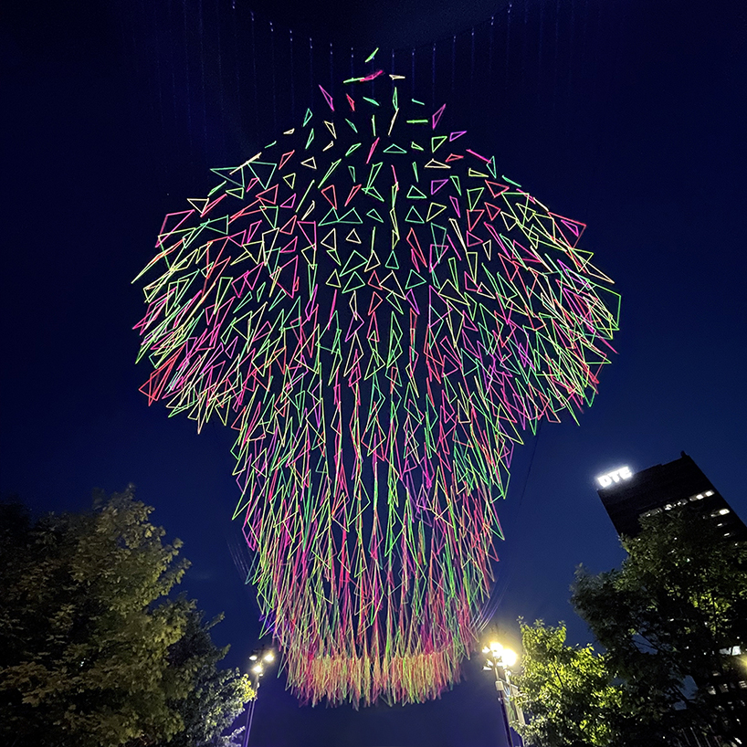 hou de sousa suspends a canopy of neon triangles over detroit designboom