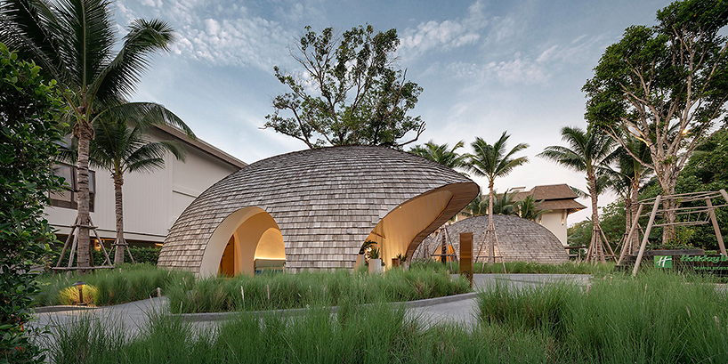 onion designs hotel's dome-shaped lobby clad in wooden shingles in thailand