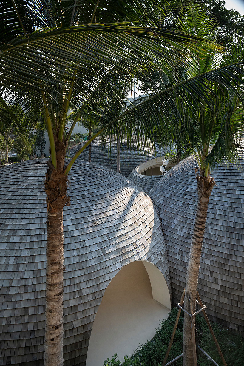 onion designs hotel's dome-shaped lobby clad in wooden shingles in thailand