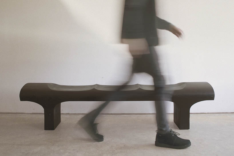 ákos huber carves reclaimed wood into monolithic bench reminiscent of native totem poles