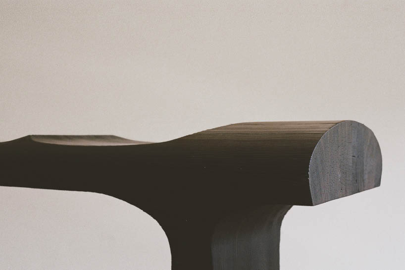 ákos huber carves reclaimed wood into monolithic bench reminiscent of native totem poles