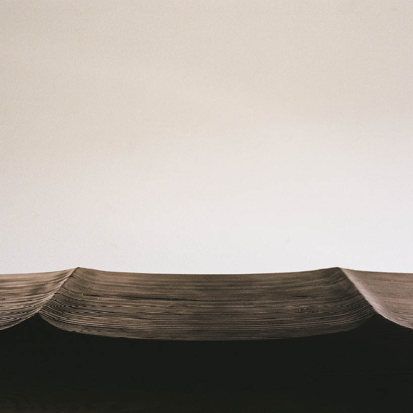 ákos huber carves reclaimed wood into monolithic bench reminiscent of native totem poles