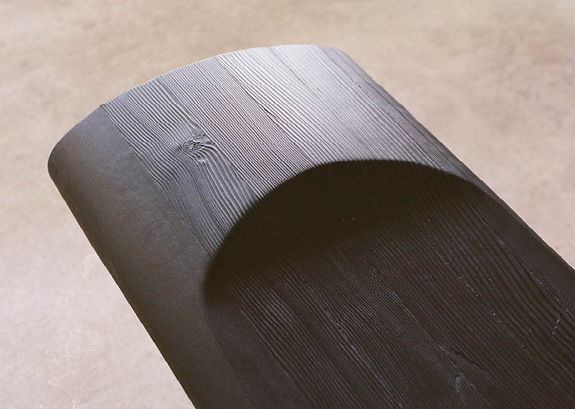 ákos huber carves reclaimed wood into monolithic bench reminiscent of native totem poles