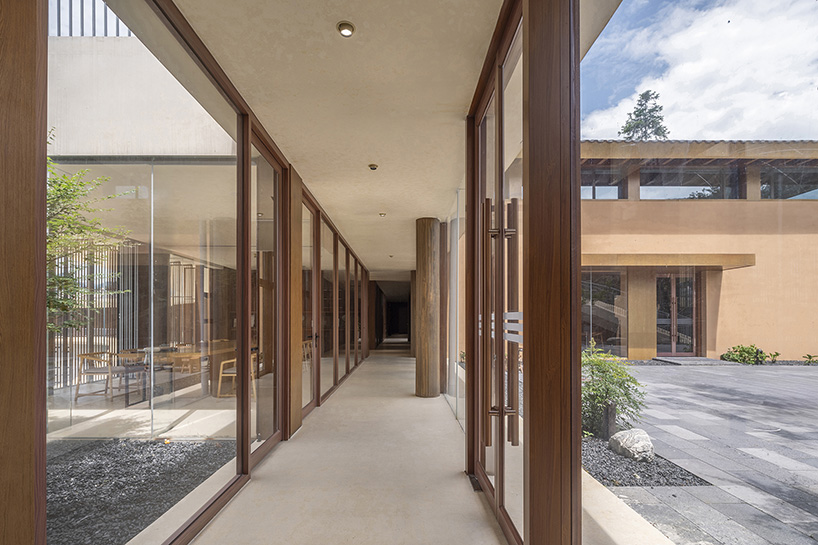 archstudio weaves resort exhibition center into the undulating landscape of dengcun, china