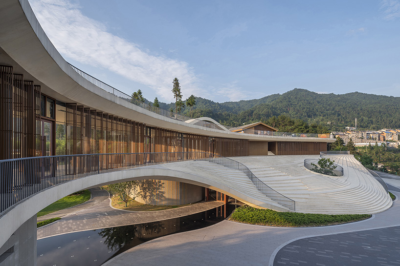 archstudio weaves resort exhibition center into the undulating landscape of dengcun, china