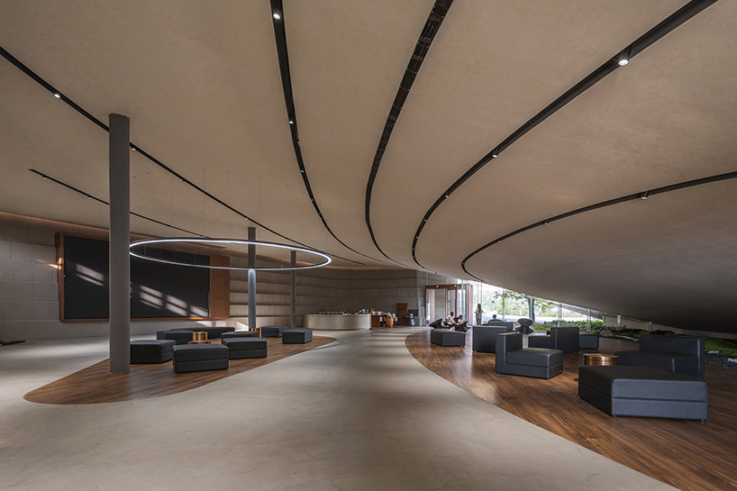 archstudio weaves resort exhibition center into the undulating landscape of dengcun, china