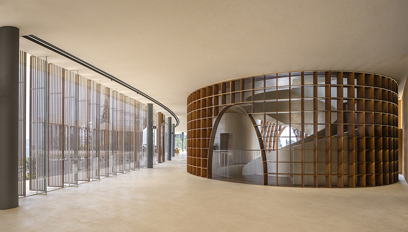 archstudio weaves resort exhibition center into the undulating landscape of dengcun, china