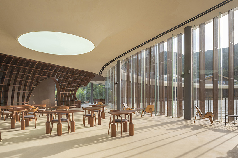 archstudio weaves resort exhibition center into the undulating landscape of dengcun, china