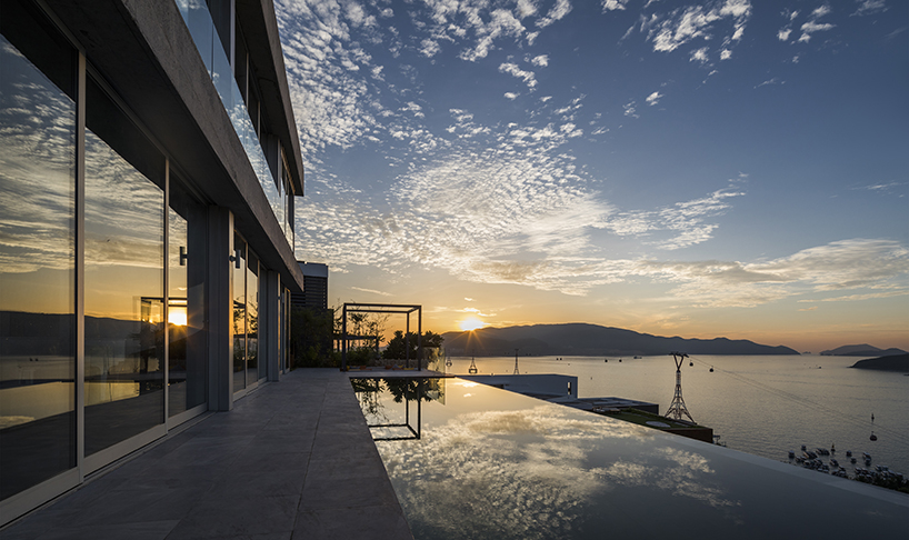 MM++ architects' villa in vietnam uses retractable glass loggia for unique ocean view