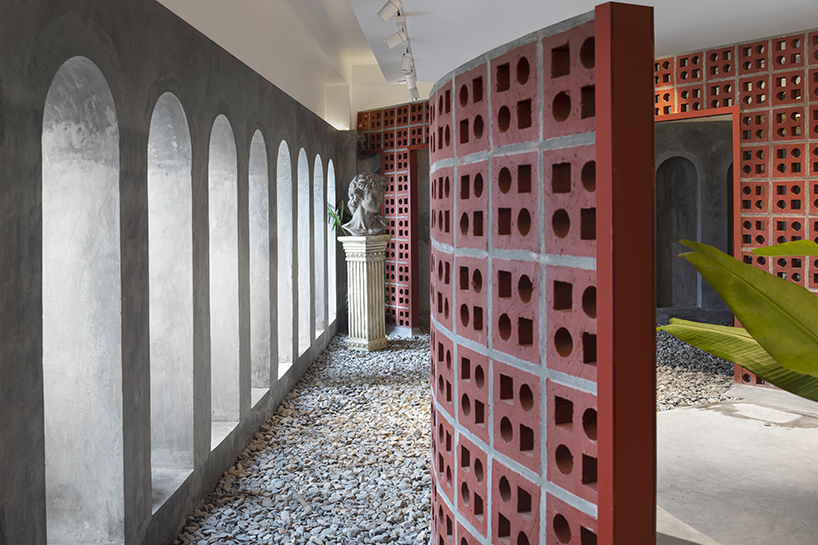 curving walls of red terracotta envelop RENESA’s 'terramater' gallery in india designboom