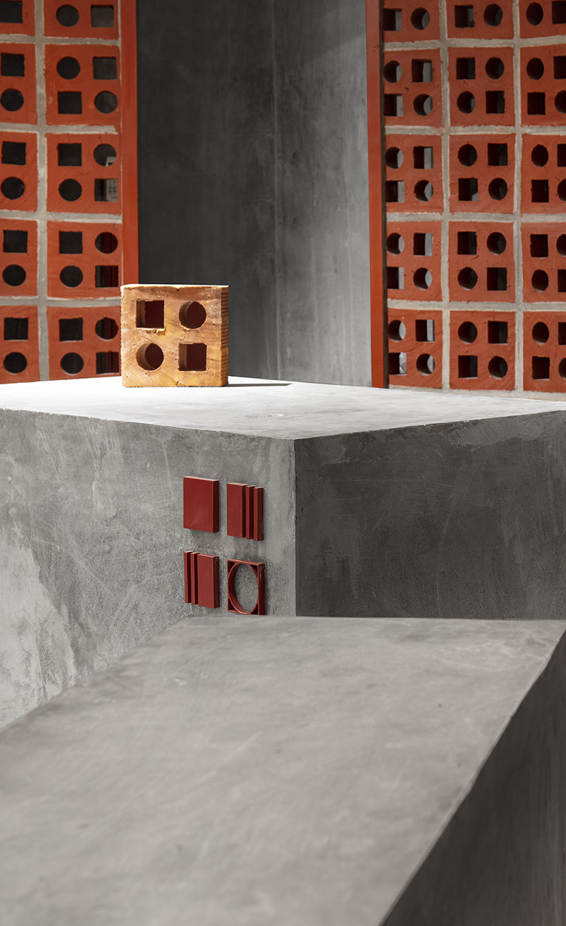 curving walls of red terracotta envelop RENESA’s 'terramater' gallery in india designboom