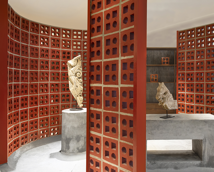 curving walls of red terracotta envelop RENESA’s 'terramater' gallery in india designboom