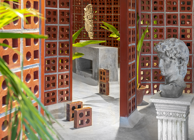 curving walls of red terracotta envelop RENESA’s 'terramater' gallery in india designboom