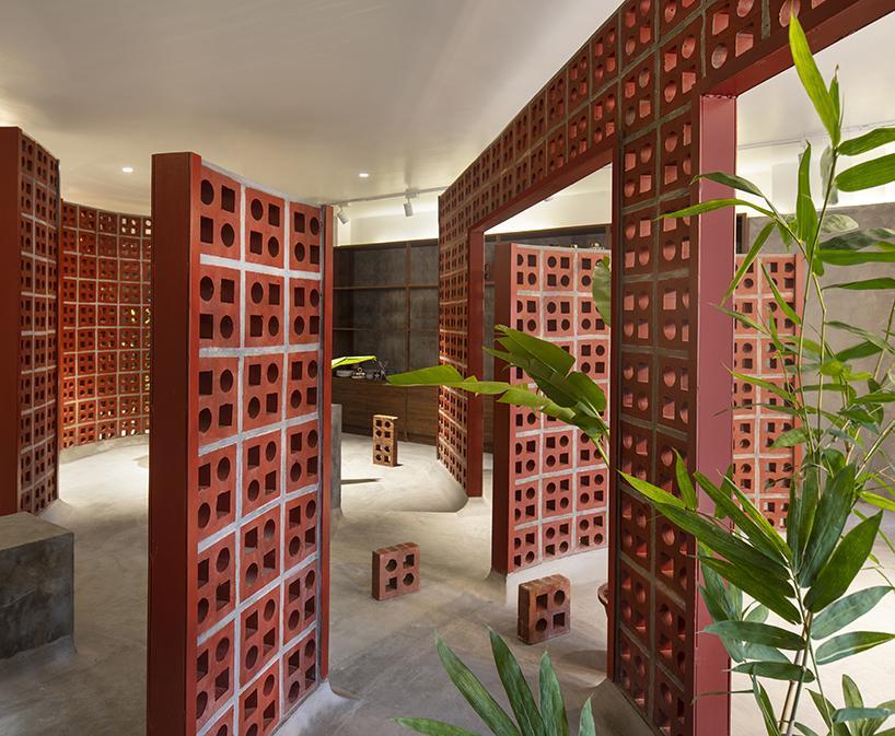 curving walls of red terracotta envelop RENESA’s 'terramater' gallery in india designboom