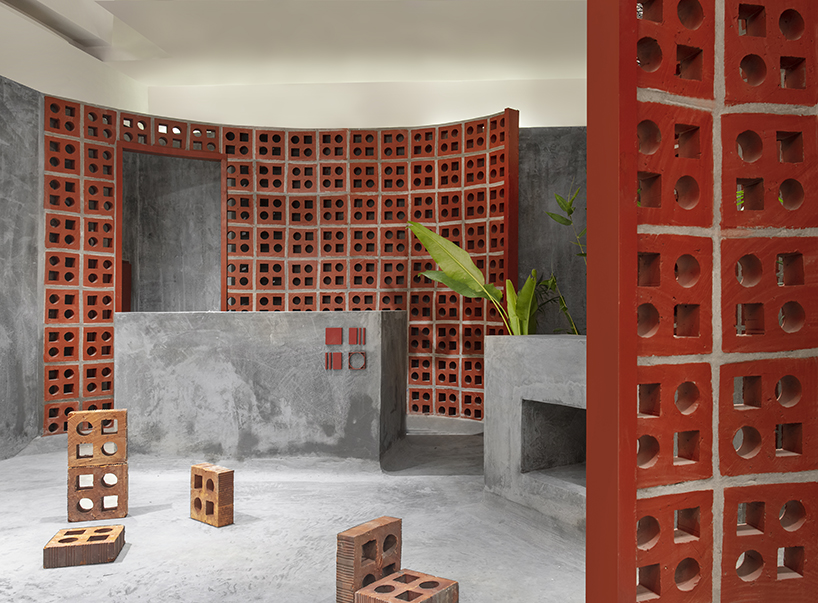 curving walls of red terracotta envelop RENESA’s 'terramater' gallery in india designboom