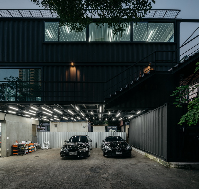 archimontage stacks shipping containers to form 'carcare' center in bangkok
