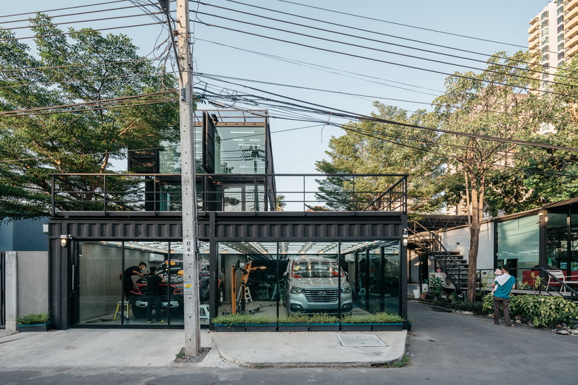 archimontage stacks shipping containers to form 'carcare' center in bangkok