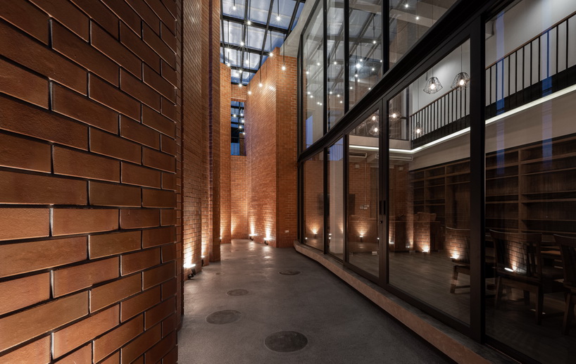 a wall of terracotta tiles shield archimontage's pakkret house in thailand designboom