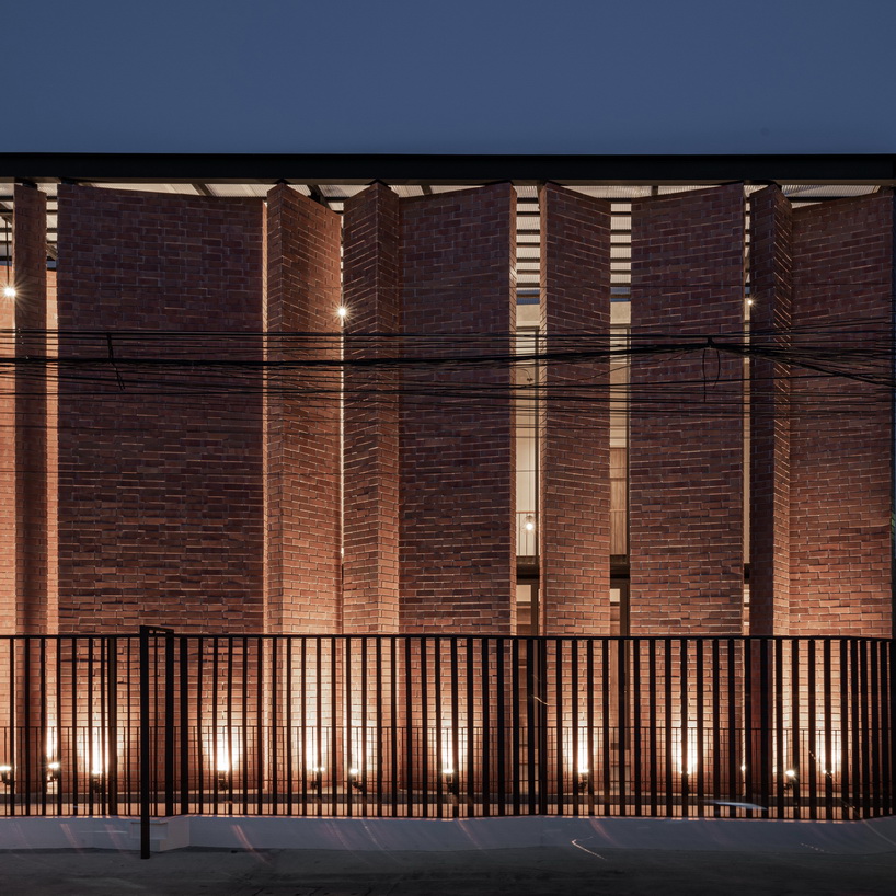 a wall of terracotta tiles shield archimontage's pakkret house in thailand designboom
