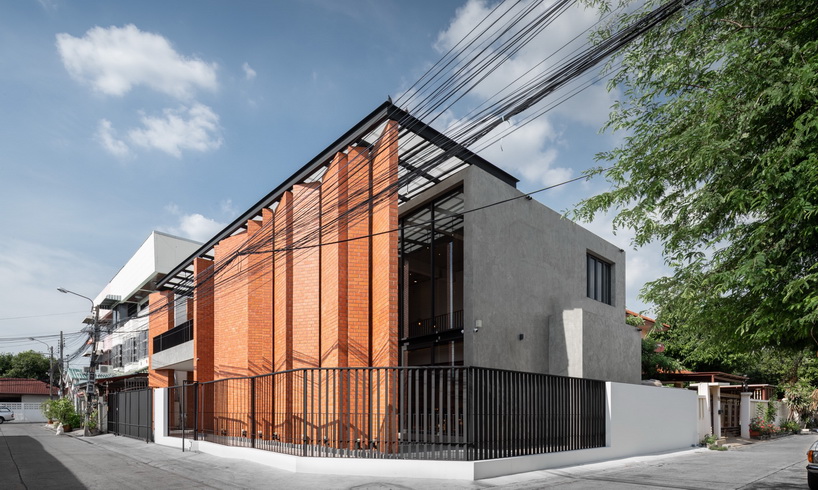 a wall of terracotta tiles shield archimontage's pakkret house in thailand designboom